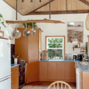 Kitchen Dining Nook: A view of the kitchen counter area with hanging pots and pans, emphasizing a functional, lived-in feel.