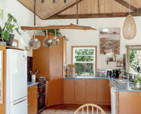 Kitchen Dining Nook: A view of the kitchen counter area with hanging pots and pans, emphasizing a functional, lived-in feel.