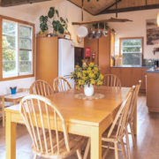 Dining Table Detail: A close-up of dining set, showcasing the natural textures of the home’s interior.